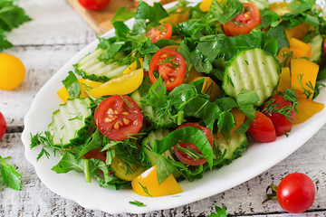 Fresh salad of tomatoes, cucumbers, peppers, arugula and dill