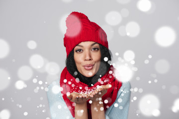 Winter girl blowing snow at you