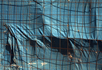  Metal grid fence with old tilt.