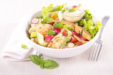 bowl of salad with chicken and sauce