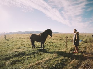 man in front of beautiful black islandic horse