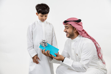 Father giving gift to his son.