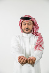 Arab man with hands cupped.