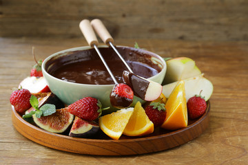 chocolate fondue with various fruits - easy and delicious dessert © Olga Kriger