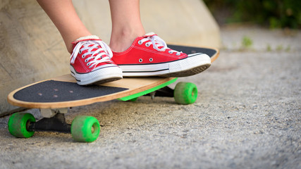 Anonymous teenage girl with skateboard