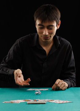 Man throwing dice on a gambling table