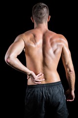 Fototapeta premium Shirtless athlete with back pain