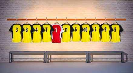 Row of Yellow and Red Football Shirts hanging on wall with bench