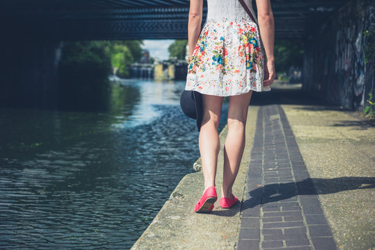 Young woman walking by canal