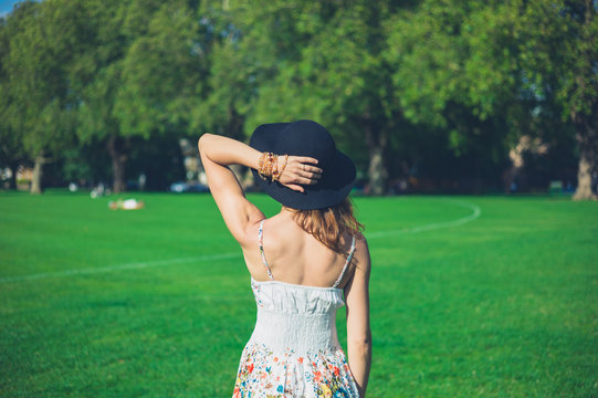 Young woman with hat standing in park