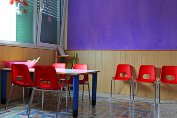 classroom with desks and red chairs