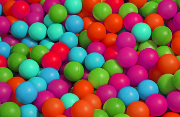 background of many colored plastic balls in a pool