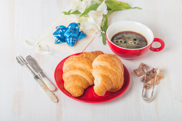 Fresh croissants with cup of hot coffee