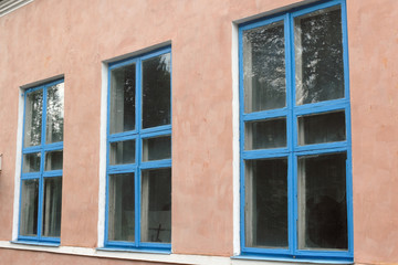 Fototapeta na wymiar Three blue window in the pink wall