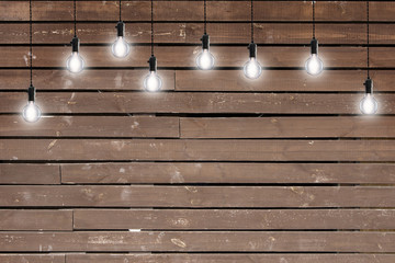 Idea concept - Vintage incandescent bulbs on wooden wall