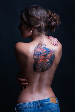 Beautiful woman with full back tattoo
