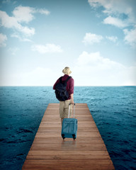 Traveler man walking in the wooden pier