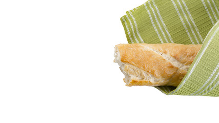 Baguette and green kitchen towel on white background