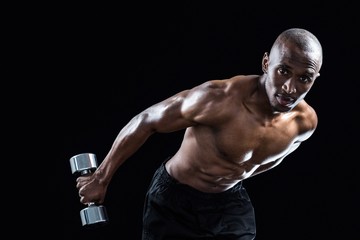 Portrait of muscular man bending while exercising