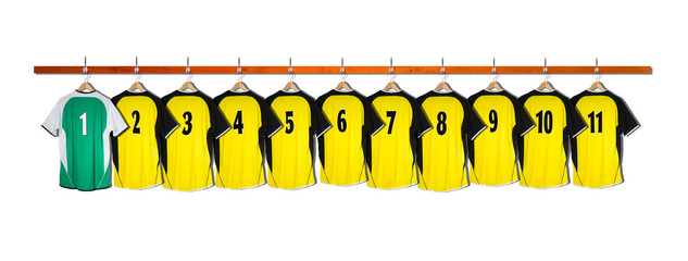 Row of Yellow and green Football Shirts hanging on wall