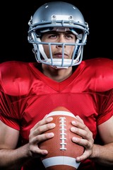 Determined sportsman holding American football