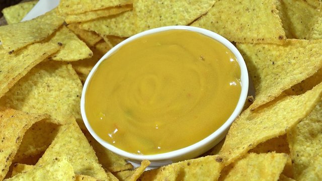Rotating Nachos with cheese dip (not loopable 4K UHD footage)