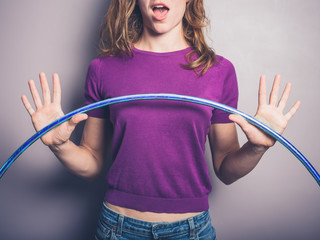 Happy young woman with hula hoop © LoloStock