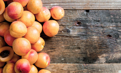 Obraz na płótnie Canvas Apricot. Organic fruits with leaf on wooden background