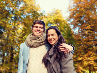 Fototapeta premium smiling couple hugging in autumn park