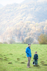father and son in autumn mountains
