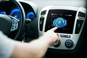 male hand setting car eco system mode on screen