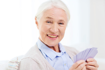 Fototapeta na wymiar happy senior woman playing cards at home