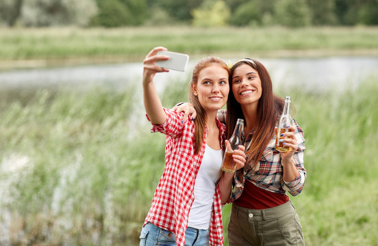 happy women taking selfie by smartphone outdoors