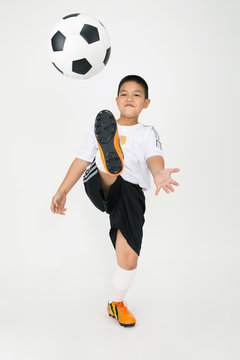 Portrait of Little asian boy with cocker ball in sport uniform