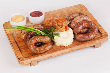 sausages with potatoes on the board green onion fries menu