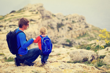 Fototapeta premium father and little daughter hiking in mountains