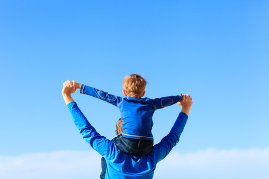 happy father and little son play on sky