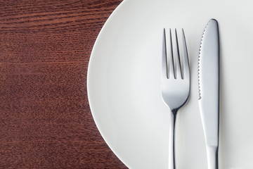 Knife and fork with plate, Close-up.
