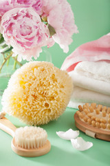 Obraz na płótnie Canvas bath and spa with peony flowers brush sponge towels