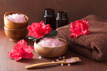 spa aromatherapy with azalea flowers and herbal salt on rustic d