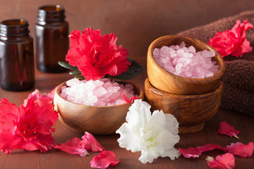 spa aromatherapy with azalea flowers and herbal salt on rustic d