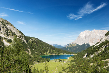 Fototapeta na wymiar idyllic blue mountain lake in austrian alps with blue sky