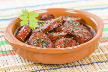 Chorizo al Vino (Spicy sausage cooked in red wine). Traditional Spanish tapas dish.
