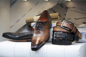 Leather men’s shoes and belts in the shoe store