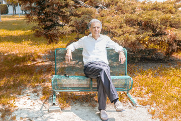 Fototapeta premium Old reassuring man resting on a bench