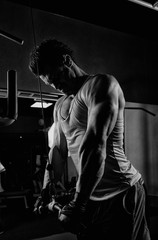 Fototapeta na wymiar fitness man bodybuilder with muscular torso workout in gym