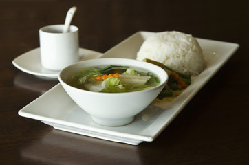 Rice topped with stir-fried pork and basil with vegetable soup