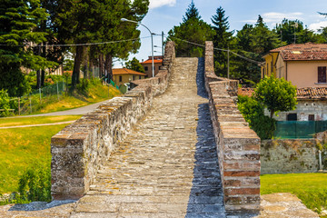 three archs medieval humpback bridge in Italy