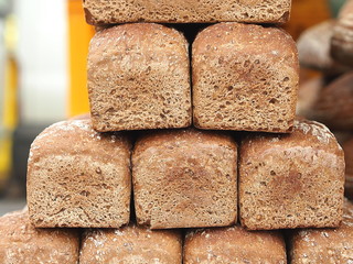 Pyramid of brown wheat-rye bread at czech farmers market. 