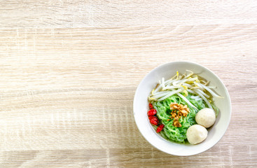 Thai Noodle with meat ball and crispy pork skin on wooden backgr